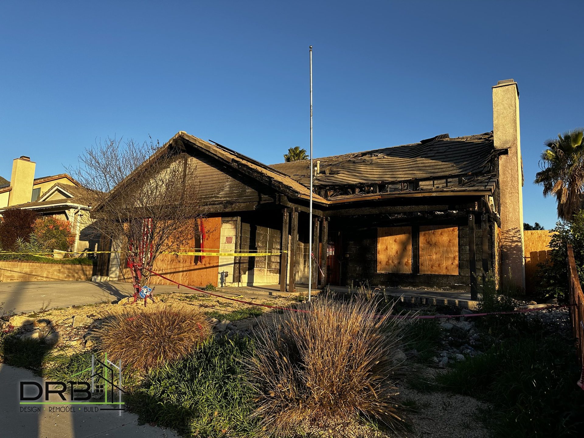 Fire-damaged home exterior before rebuild